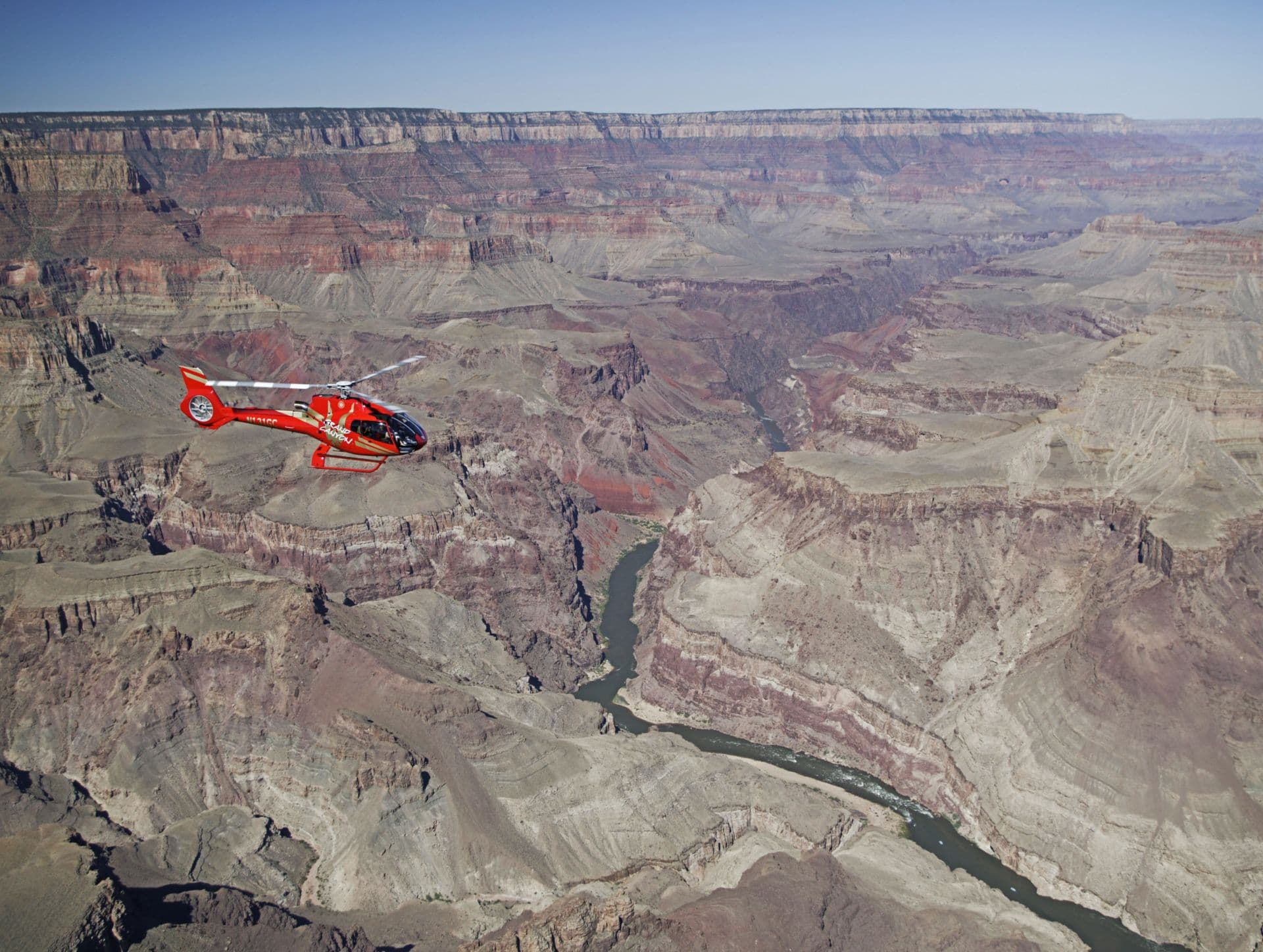 Red helicopter flying at Grand Canyon South Rim