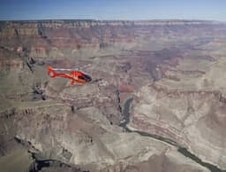 Red helicopter flying at Grand Canyon South Rim